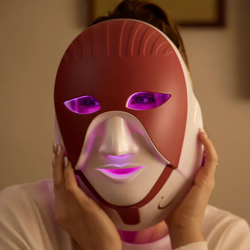 Woman using Cleolight LED mask with purple light therapy for anti-aging and skin rejuvenation.