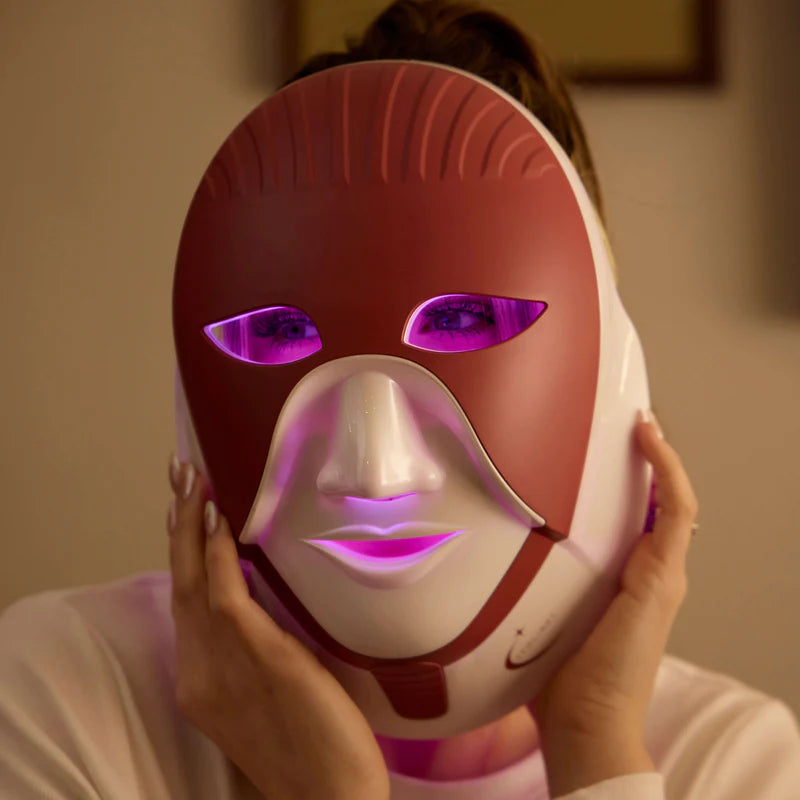 Woman using Cleolight LED mask with purple light therapy for anti-aging and skin rejuvenation.