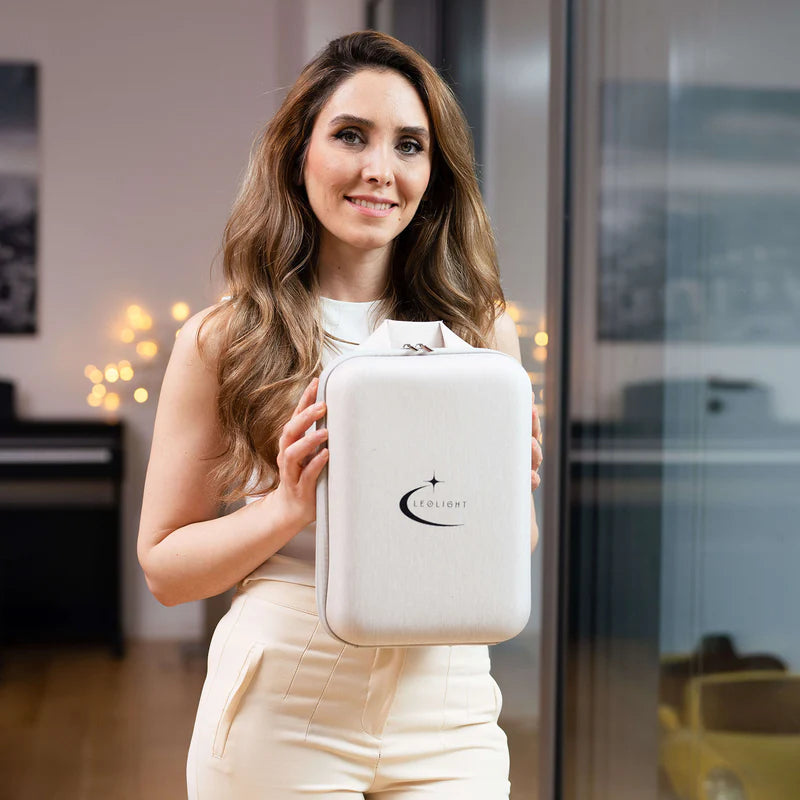 Smiling woman holding Cleolight LED mask travel case – convenient storage for light therapy device.